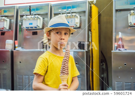 Little tourist boy eating 32 cm ice cream. 1 foot long ice cream. Long ice cream is a popular Little tourist boy eating 32 cm ice cream. 1 foot long ice cream. Long ice cream is a popular 59601724