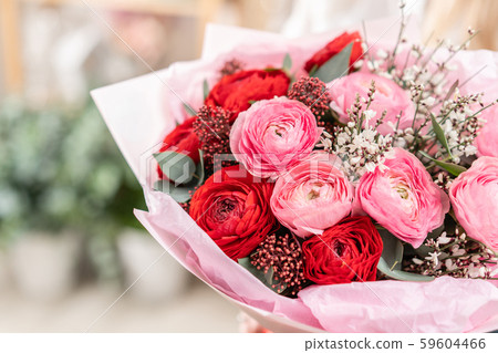 Beautiful bouquet of mixed flowers in womans hands. the work of the florist at a flower shop 59604466