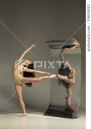Young and stylish modern ballet dancer on brown background Young and stylish modern ballet dancer on brown background 59609083