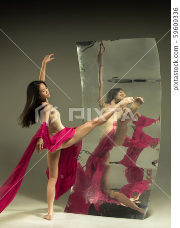 Young and stylish modern ballet dancer on brown background Young and stylish modern ballet dancer on brown background 59609336