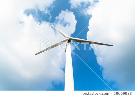 Wind turbine against a cloudy blue sky Wind turbine against a cloudy blue sky 59609988