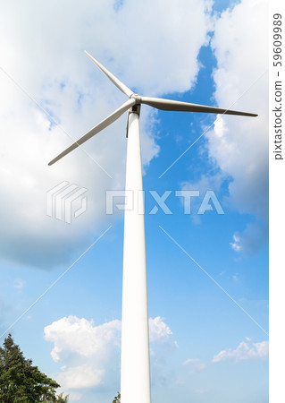 Wind turbine against a cloudy blue sky 59609989