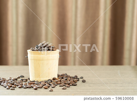 Coffee beans in wood bucket Coffee beans in wood bucket 59610008