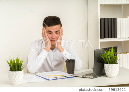 Tired asian businessman sleeping in office. Middle Tired asian businessman sleeping in office. Middle 59612621