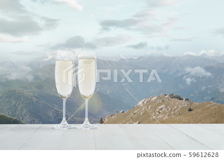 Champagne in glasses and landscape of mountains on background 59612628