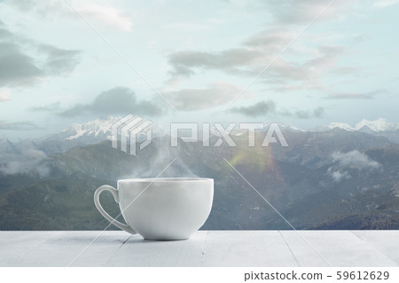 Single tea or coffee mug and landscape of mountains on background Single tea or coffee mug and landscape of mountains on background 59612629