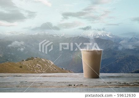 Single tea or coffee mug and landscape of mountains on background Single tea or coffee mug and landscape of mountains on background 59612630