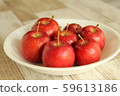 Seven princess apples on a white plate 59613186