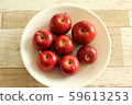 Seven princess apples on a white plate 59613253