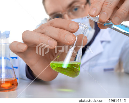 Close up view of a hands of male researcher carrying out scientific research in a lab. Close up view of a hands of male researcher carrying out scientific research in a lab. 59614845