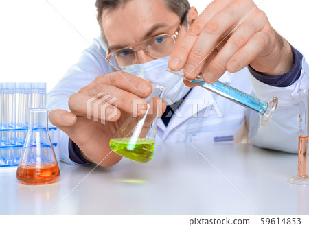 Male researcher carrying out scientific research in a lab. Male researcher carrying out scientific research in a lab. 59614853