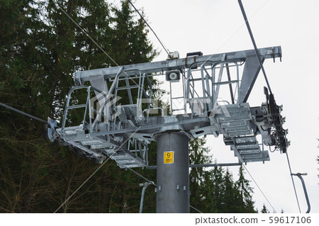 A chair lift and its elements close up, skiers are A chair lift and its elements close up, skiers are 59617106