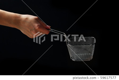 Hand holding metallic basket for french fries 59617577