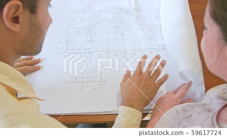 a man shows woman a drawing on paper a man shows woman a drawing on paper 59617724