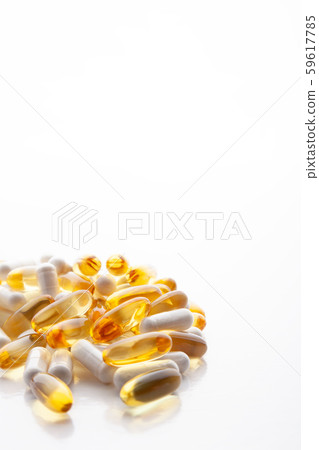 Tablets, pills, capsules, drugs pouring out of white bottle on white background. Sport, healthy 59617785