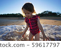 A young girl running on the beach 59617797