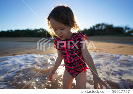 A young girl running on the beach 59617797
