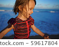 A young girl running on the beach 59617804