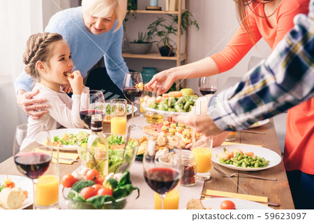 Young and old generation concept. Elderly woman embrace little girl 59623097