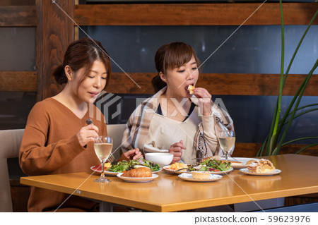 A woman dining at a restaurant 59623976