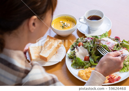 A woman dining at a restaurant A woman dining at a restaurant 59626468