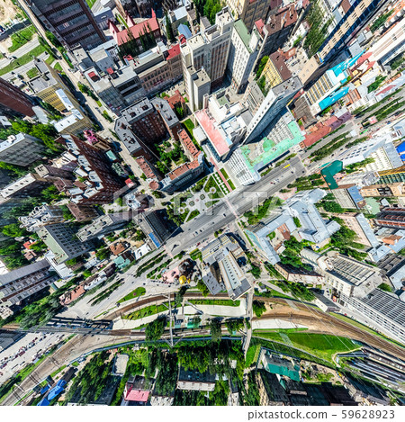 Aerial city view with crossroads and roads, houses, buildings, parks and parking lots. Sunny summer 59628923