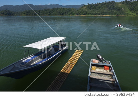 fiber speed boat floating near the boathouse. 59629454