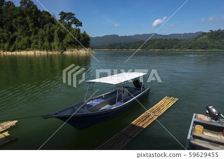 fiber speed boat floating near the boathouse. fiber speed boat floating near the boathouse. 59629455