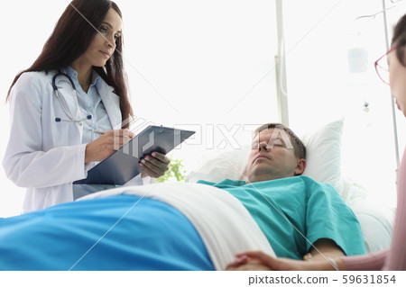 Pretty physician writing diagnosis Pretty physician writing diagnosis 59631854