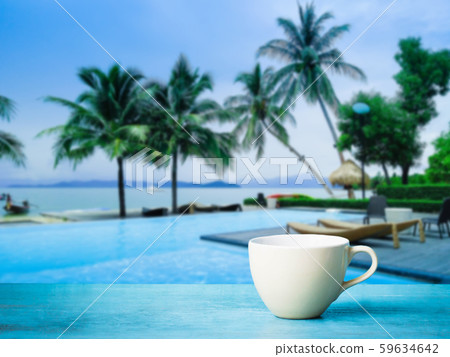 White cup  coffee on blue table with seaside for lifestyle and blogger concept. Remote work.  59634642