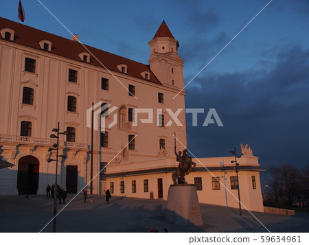 Slovakia, Bratislava castle and equestrian statue of King Swartpurk illuminated by the setting sun 59634961
