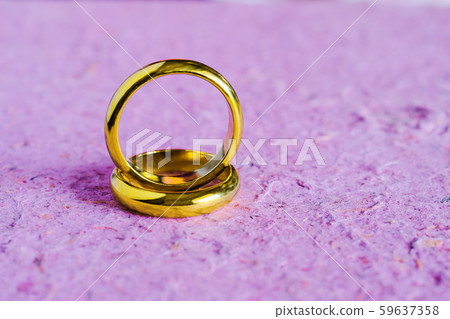 Duo golden wedding ring on paper Duo golden wedding ring on paper 59637358