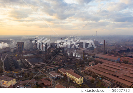 Aerial view. Pipes Throwing Smoke in the Sky. Large Plant on the Background of the City. Aerial view. Pipes Throwing Smoke in the Sky. Large Plant on the Background of the City. 59637723