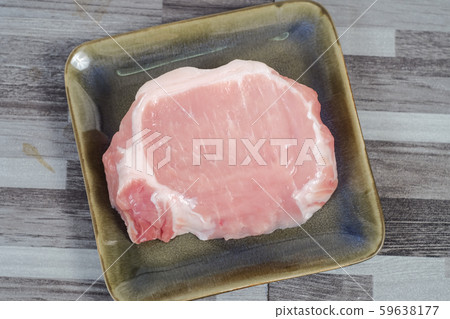 Uncooked fresh pock meat on disc background. 59638177