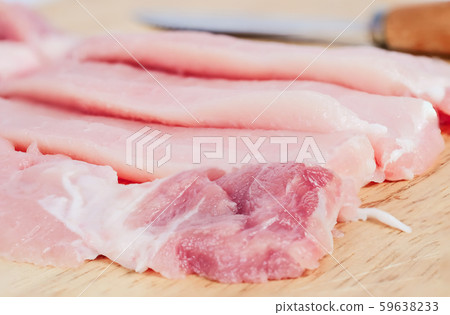 Uncooked slies of fresh pock meat on wood 59638233
