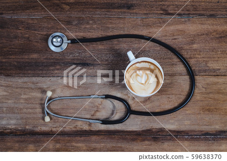 black Stethoscope and late art coffee on wood black Stethoscope and late art coffee on wood 59638370