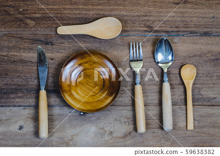 wooden surface and a wooden spoon and fork on wood 59638382