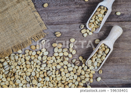 Organic Raw coffee beans in wood spoon on wood Organic Raw coffee beans in wood spoon on wood 59638401