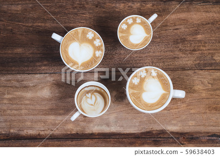 Hot late art coffee cups on wood table. Hot late art coffee cups on wood table. 59638403