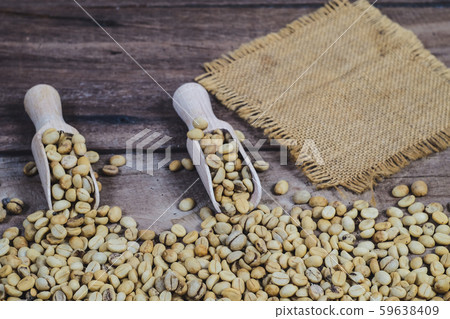 Organic Raw coffee beans in wood spoon on wood 59638409