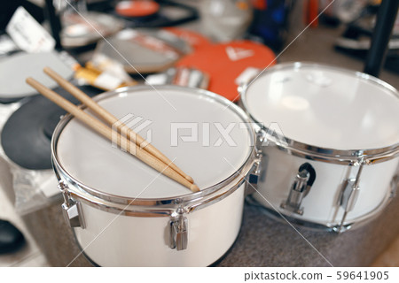 Drums and drumsticks on showcase in music store Drums and drumsticks on showcase in music store 59641905