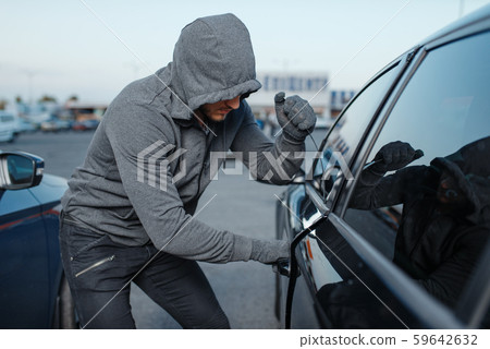 Car thief breaking door lock, criminal job Car thief breaking door lock, criminal job 59642632