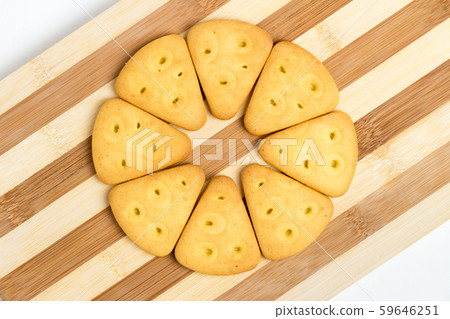 Triangular cookies folded around lie on a blackboard 59646251