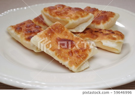 Baked snacks wrapped in cheese with dumpling skin Baked snacks wrapped in cheese with dumpling skin 59646996