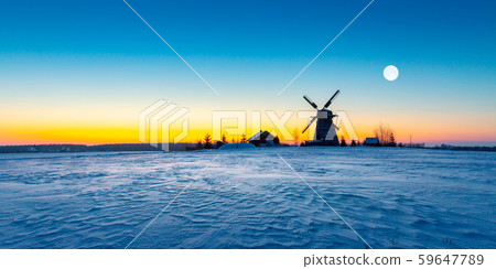 Wooden windmill on background winter sunrise. Dudutki village, Minsk Region, Belarus 59647789