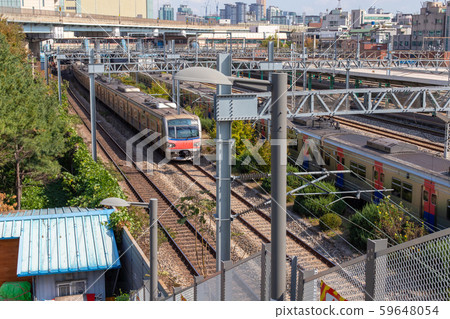 Railroad infrastructure and train passing by. Railway power supply system. Railway facilities Railroad infrastructure and train passing by. Railway power supply system. Railway facilities 59648054