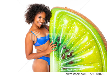 Pretty african female stands in swimsuit with rubber beach kiwi mattress and smiles isolated on 59648076