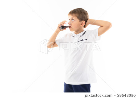 A little blonde boy drinks cola, picture isolated on white background 59648080