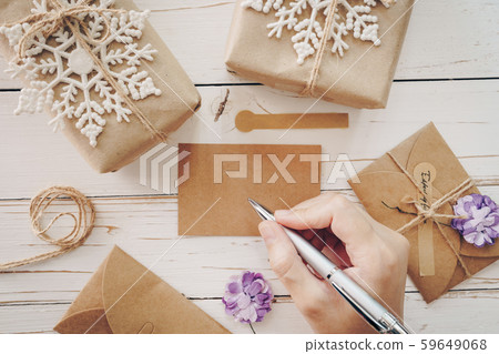 Close up of hands woman writing empty wishlist and 59649068