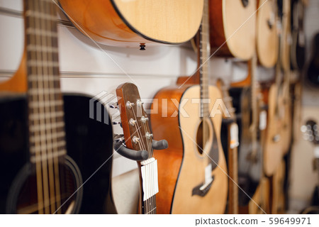 Rows of acoustic guitars in music store Rows of acoustic guitars in music store 59649971